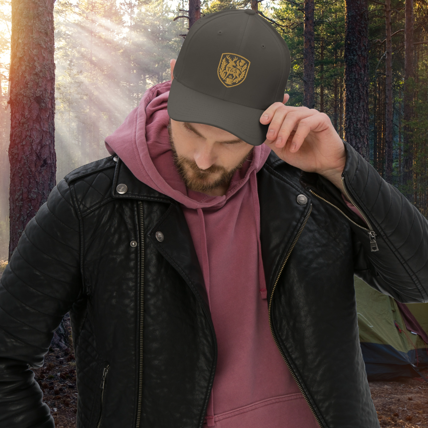 Person wearing a grey cap with a Thistle & Stag Coffee Co. logo in a forest setting