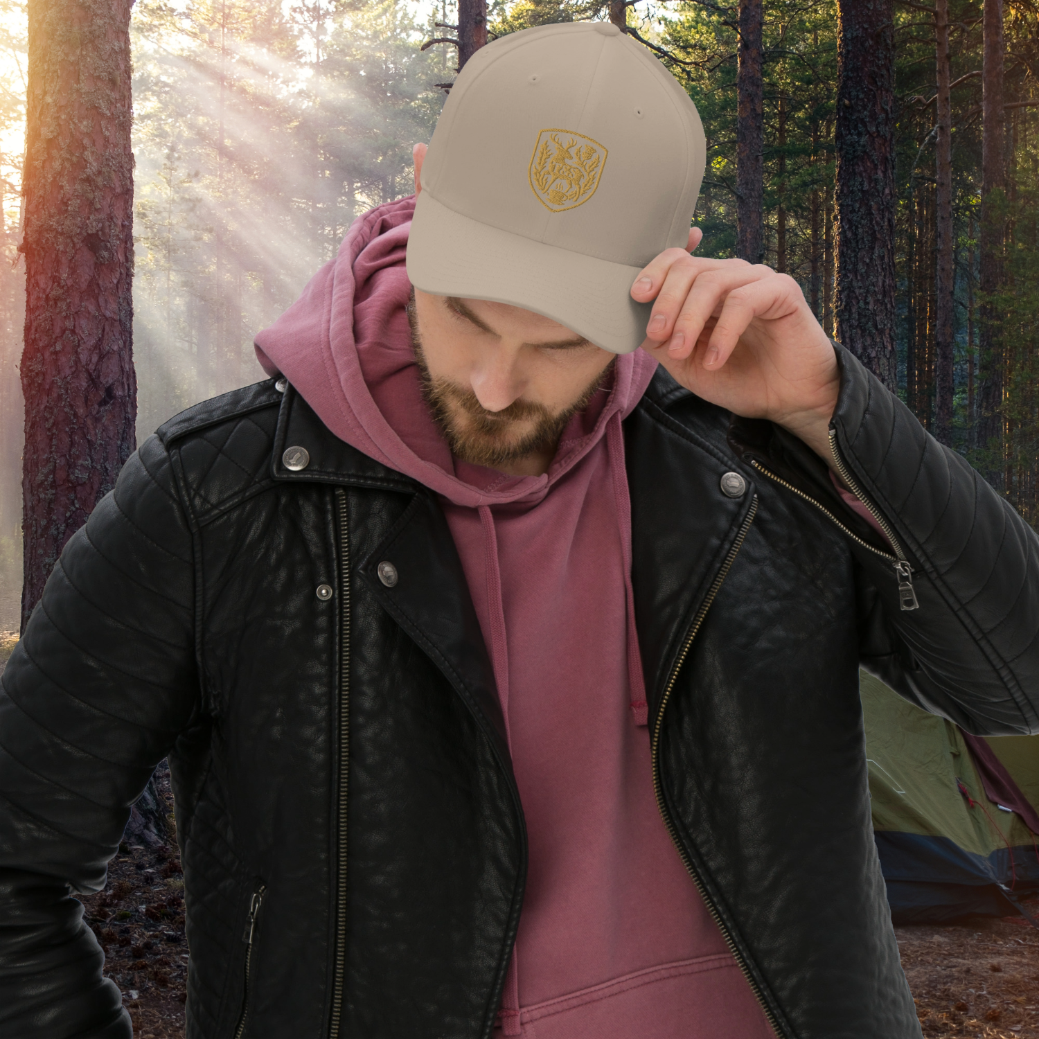 Person wearing a tan cap with a Thistle & Stag Coffee Co. logo in a forest setting