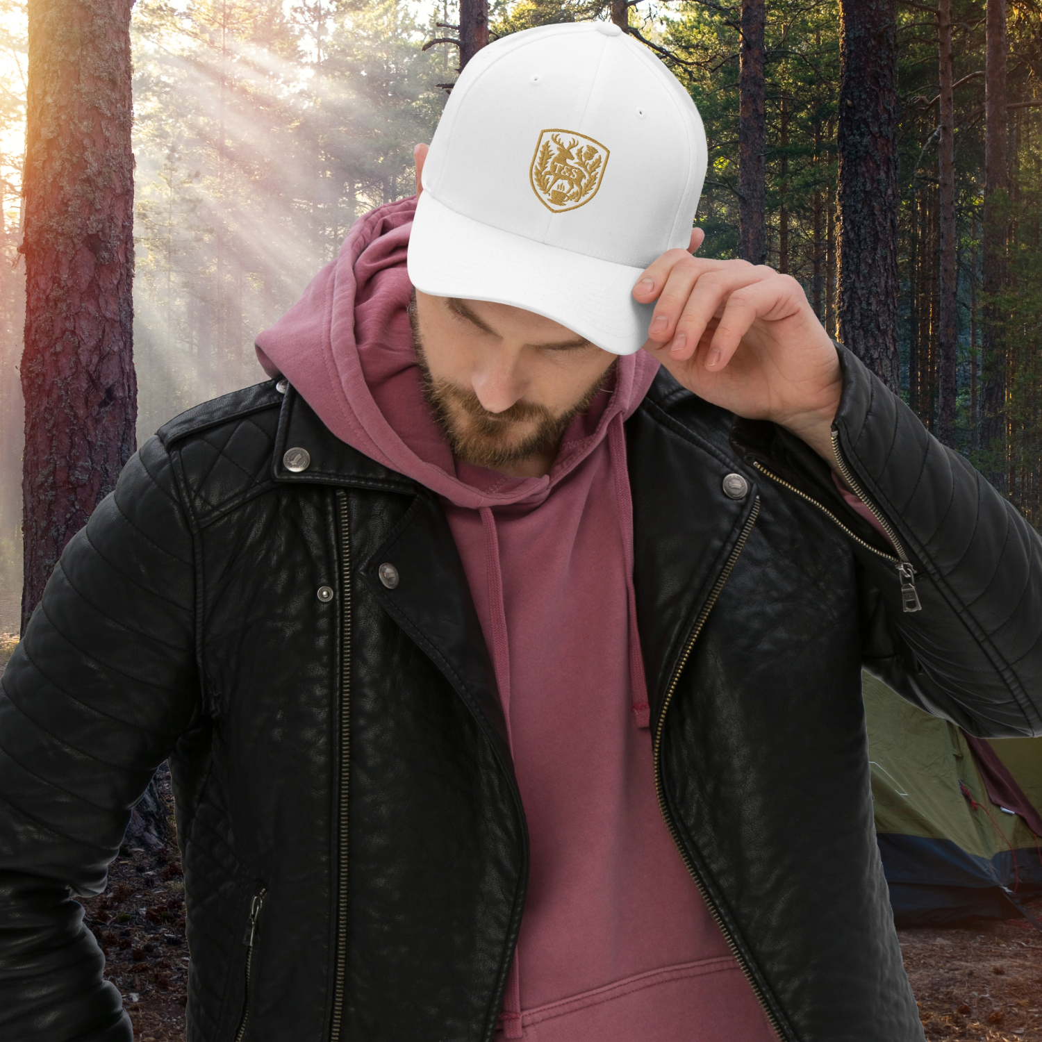 Person wearing a white cap with a Thistle & Stag Coffee Co. logo in a forest setting
